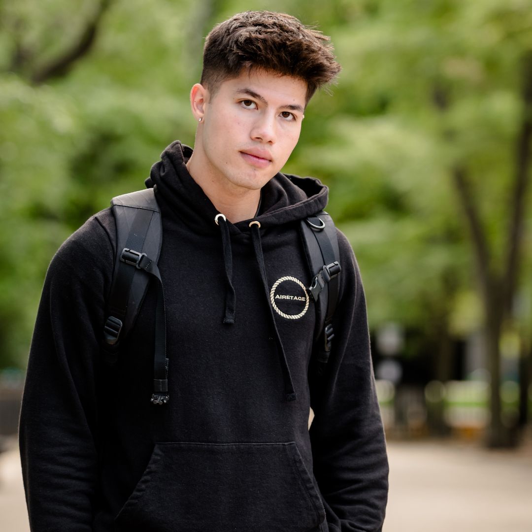 Man with earing and backpack wearing hemp sweatshirt